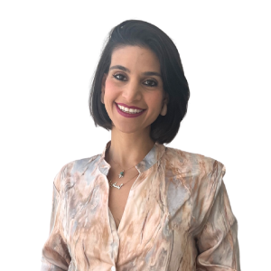 Person smiling in a patterned blouse, short dark hair, white background.