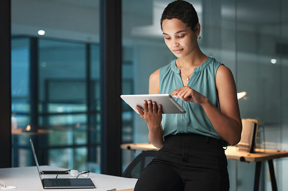 Female executive checking out talent trends in an office on a device