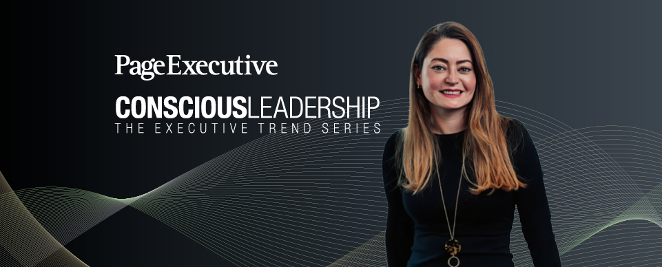 Page Executive Conscious Leadership banner featuring a smiling woman with long blonde hair, wearing a black outfit and a gold necklace, against a dark background with abstract wave patterns.