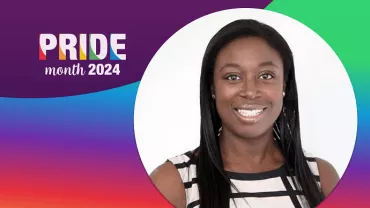 Person smiling in a black-and-white striped top with Pride Month 2024 design.