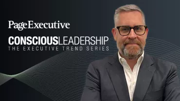 Man in a suit and glasses with 'Page Executive Conscious Leadership: The Executive Trend Series' text in the background.