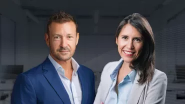 Lorena Gutiérrez Filomeno and Olly Riches in front of an office background