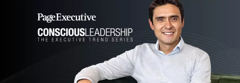 Person sitting on a green couch with a conscious leadership series backdrop.
