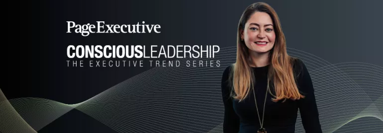 Page Executive Conscious Leadership banner featuring a smiling woman with long blonde hair, wearing a black outfit and a gold necklace, against a dark background with abstract wave patterns.